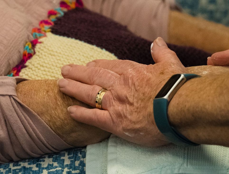 A person holds another person's hand